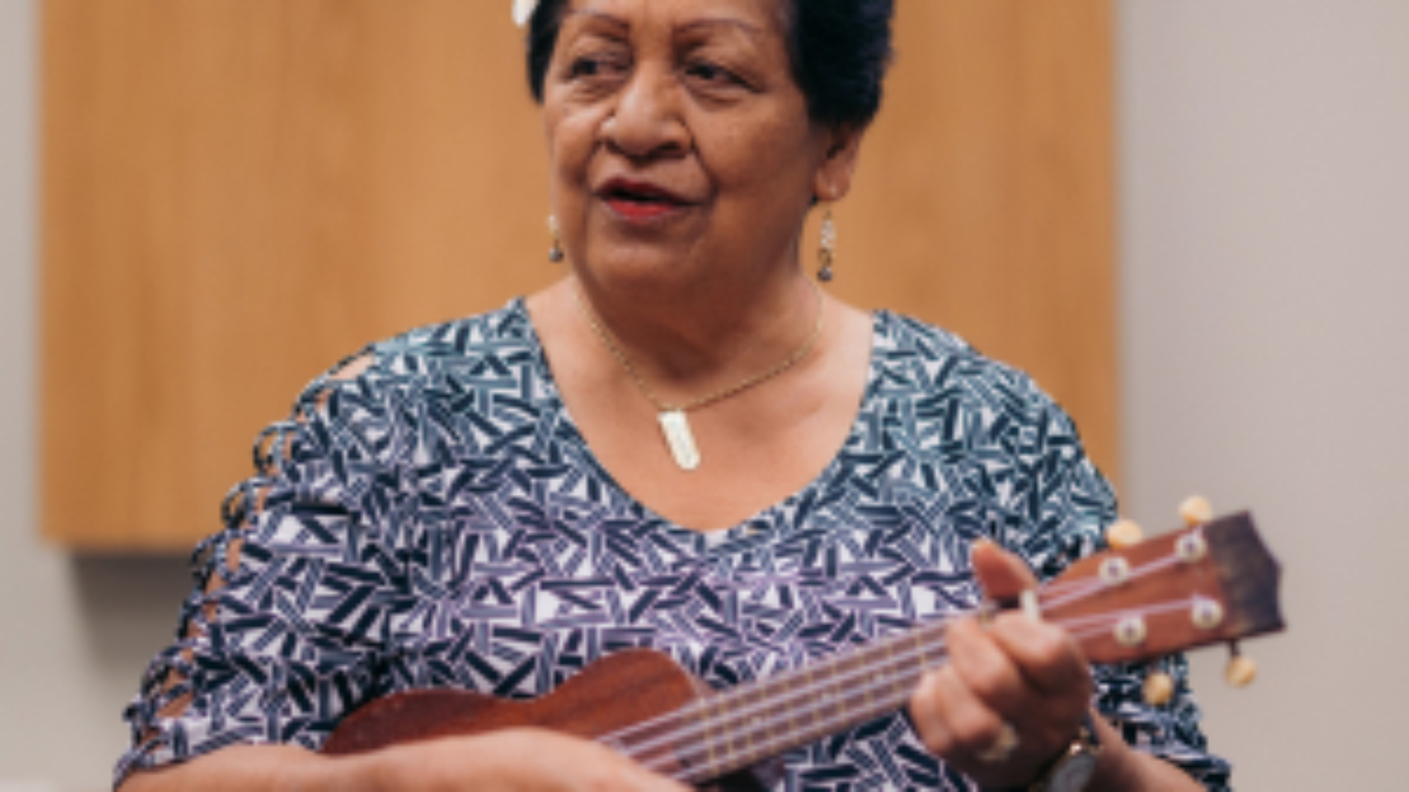 A woman playing the ukulele